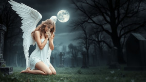 beautiful-female-angel-kneeling-in-abandoned-cemetery-under-grey-moon.jpg